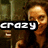 Pixelated image of a person with light brown hair and beard, wearing dark clothing against a blurred background with the word 'crazy' in white block letters on black bar.