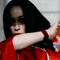 A person in a red patterned top and black head covering performs a sequence of arm movements against a light gray background.