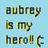 Pixelated text reads "Aubrey is my hero! (" on a light blue background with green and dark gray lettering.