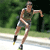 Pixelated static image of a person running outdoors in athletic wear with green foliage background.