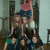 A pixelated group of people in a crowded indoor setting with visible clothing colors and partial background elements.