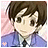 Pixelated anime-style icon of a character with brown hair, dark eyes, and a neutral expression wearing a blue jacket over a white shirt and black tie against a pink gradient background with a small pink star.