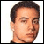 Pixelated static image of a person's head and neck with short dark hair, light skin tone, visible facial features including eyes, nose, mouth, and ear, against a plain white background.