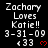 Pixelated text displays 'Zachary Loves Katie!!' with date '3-31-09' and '«33' followed by a red heart symbol on a black background.