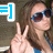 A pixelated image shows a person with brown hair wearing dark sunglasses and a blue top, making a peace sign with their right hand, next to a blue and white icon with a number one.