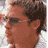 Static 48x48 pixel icon showing a close-up of a person's face with brown hair and glasses, rendered in low-resolution pixel art style against a light background.