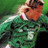 Pixelated static image of a soccer player in green uniform with visible number 5, brown hair, and red mouth detail against blurred green background.