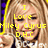 Pixelated image of a person with light brown hair wearing a white top, overlaid with yellow text reading "I Love Miley Cyrus D.H.C.".