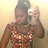 A person in a patterned top holds a camera, with red displaying yellow pixelated text reading HATERS GET ON YOULLS JOB and DONT WORRY ABOUT US BARRETTS