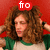 A person with curly brown hair wears a green and white shirt against a red background, with text above their head changing from 'fro' to 'fire' then 'crotch!'