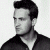 Static grayscale pixel art of a person's head and shoulders in profile view with dark hair, wearing a dark jacket over a light shirt against a white background.