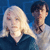Two pixelated figures with light and dark hair stand side-by-side against a blue background, one with long light hair and the other with short dark hair.