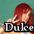 A static image shows a person with long red hair, a peace sign gesture, and the text 'Dulce' over a teal background.