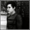 Black-and-white animated sequence showing a person in dark clothing against a textured background, with changing text overlays.