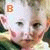 A child's face with changing text above the head and a small pink heart in one frame.