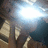 Pixelated static image shows a bright light source with blue and white tones dominating the upper portion, while lower sections contain brown and beige shapes against dark background.