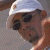 A split-frame contact sheet showing a pixelated image of a person wearing sunglasses and a white cap on the left, with green text reading "Original Icons .com" on a dark green background on the right.