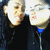 Two pixelated faces in profile view, one with light hair and a dark top, the other with lighter skin tone and blue accents on clothing.