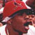 Static pixelated image of a person wearing a red cap and dark clothing with visible facial features, rendered in low resolution.