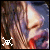 Animated close-up of a woman's face with long light brown hair, showing two distinct states: one with white skull-and-crossbones icon and another with red version.