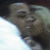Pixelated close-up of a person's face with closed eyes, dark hair, and light skin against a gradient background.
