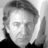 Black-and-white pixelated image of a person with light hair and dark clothing, next to text reading 'Alan Rickman' on black background.
