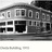 Static grayscale image of a building facade with multiple rectangular windows and a central dark doorway, rendered in low-resolution pixelation.