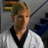 Pixelated image of a person in a white martial arts uniform with black trim, next to text reading 'Trent Malloy is MY HERO <3' on a black background.