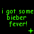 Green pixelated text on black background reads "i got some bieber fever!" with small symbols changing across three of identical text