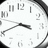 A clock face with black hands and numerals on a white background, surrounded by yellow text reading "Wishin Time Would Stop" and "Right in It's Tracks. Everytime I hear That Song I GO BACK!".