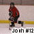 Pixelated image of a hockey player in red jersey and black pants holding a stick on ice rink with yellow line and text 'Joah #12' at bottom.