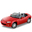 Red convertible car with gray interior and black accents, viewed from front-left angle on solid gray background.