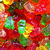 A static pixelated image with vibrant red, orange, yellow, green, and pink hues forming an abstract composition of overlapping shapes.