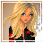 Pixelated image of a woman with long blonde hair wearing a black jacket with red accents, set against a light brown background.