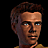 Pixelated portrait of a man with brown hair and blue eyes, wearing a yellow shirt against black background.