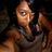Pixelated image of a person with light skin tone wearing dark clothing, making a raised middle finger gesture against a dark background.