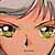 Pixelated close-up of a face with light skin tone, green eyes, and brown hair, showing only the upper portion from forehead to chin.