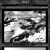 Black-and-white pixelated image showing abstract cloud-like shapes within a framed border.