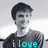 A grayscale image of a person with short dark hair wearing a dark shirt, with cyan text overlaid in three separate sections.