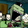 Animated cartoon scene with green-skinned character, large mouth, and pink teeth in classroom setting.