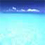 Pixelated gradient image transitioning from dark blue at top to light cyan at bottom with faint white cloud-like shapes near the horizon line.