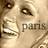 Pixelated close-up of a light-skinned face with dark eyes and mouth, featuring partial text 'PANS' in blocky letters.