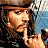 Pixelated character with brown hair and hat, holding finger to lips in shushing gesture