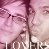 Two people in close proximity with a pink-toned filter, one wearing glasses, the other with visible hair strands, with partial text 'LOVERS' at the bottom.