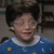 A child in a blue sweater with yellow and white patterns appears in three showing slight head movement