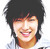 Static pixelated image of a smiling person with dark hair and light skin, wearing a white shirt against a plain background.