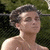 Two side-by-side frames of a pixelated animated icon showing a shirtless person with short dark hair in outdoor settings, left frame against green foliage and right frame against light stone background.