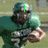 A football player in a green uniform holding a ball, with changing text overlays