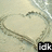 A heart drawn in sand with text overlays reading "idk I'm only in 6th grade!" across four
