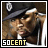 Pixelated static image of a person wearing a dark cap with a white emblem, featuring visible text "50CENT" at the bottom in mixed black and yellow lettering.
